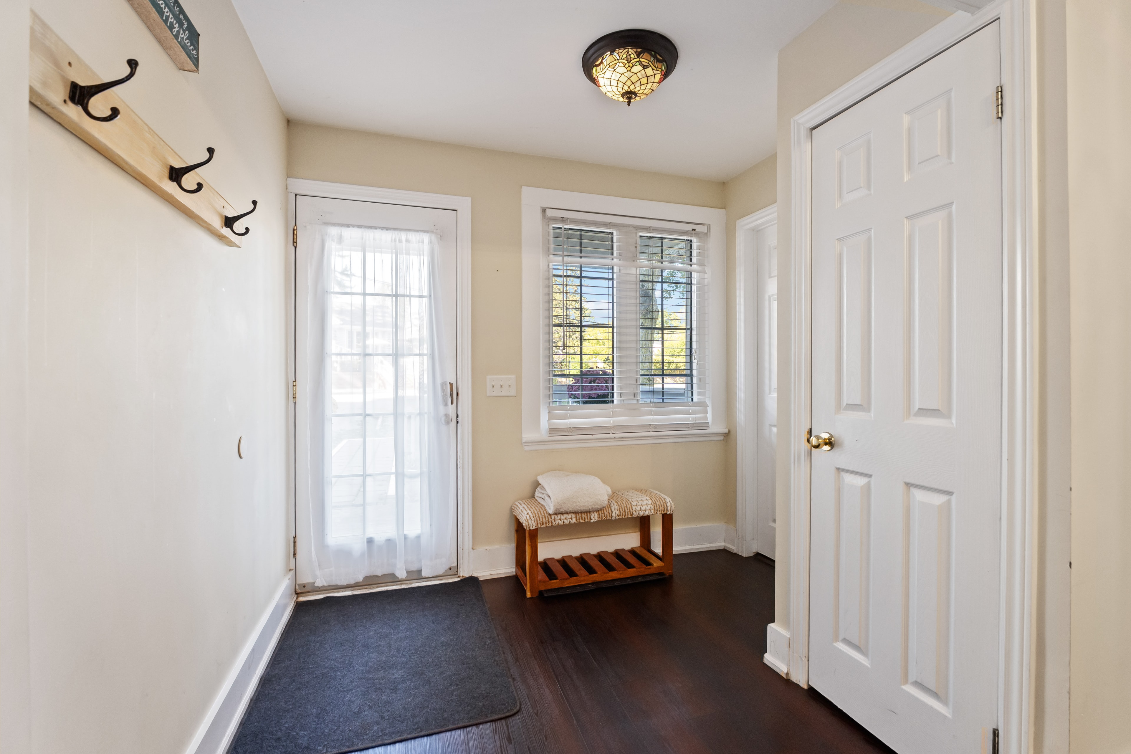 Welcoming entryway with coat hooks and hardwood floors