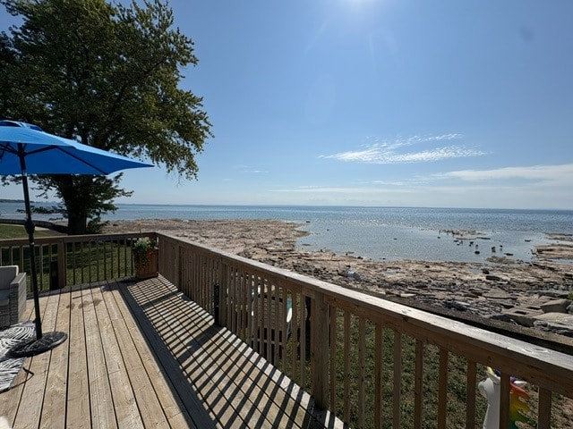 Deck with blue umbrella overlooking Lake Erie on a sunny day